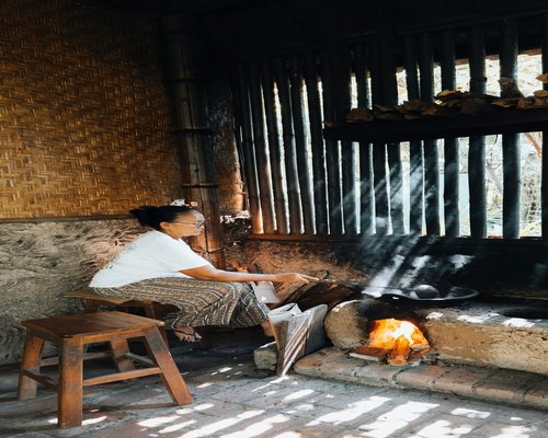 Person taking off shoes at the entrance of an Indonesian home